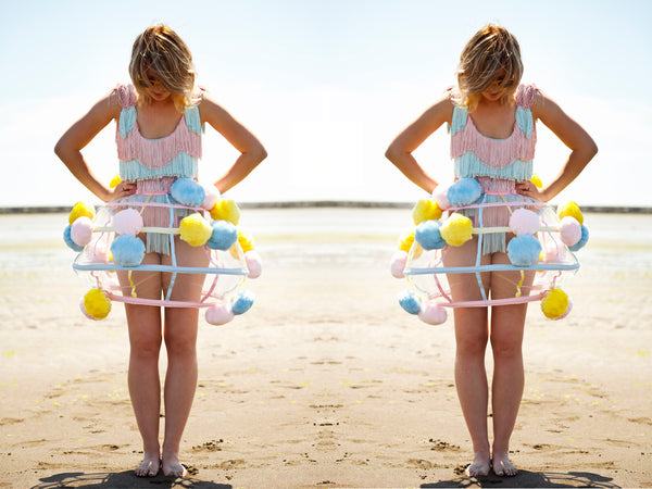 SOLD OUT Pastel Fringe Bodysuit model looking down with pom pom skirt